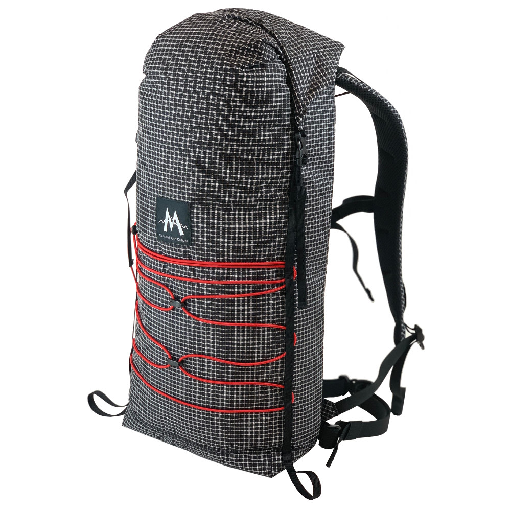 A 3/4 side view of the MLD Core pack in Black Beauty with red bungee cord.
