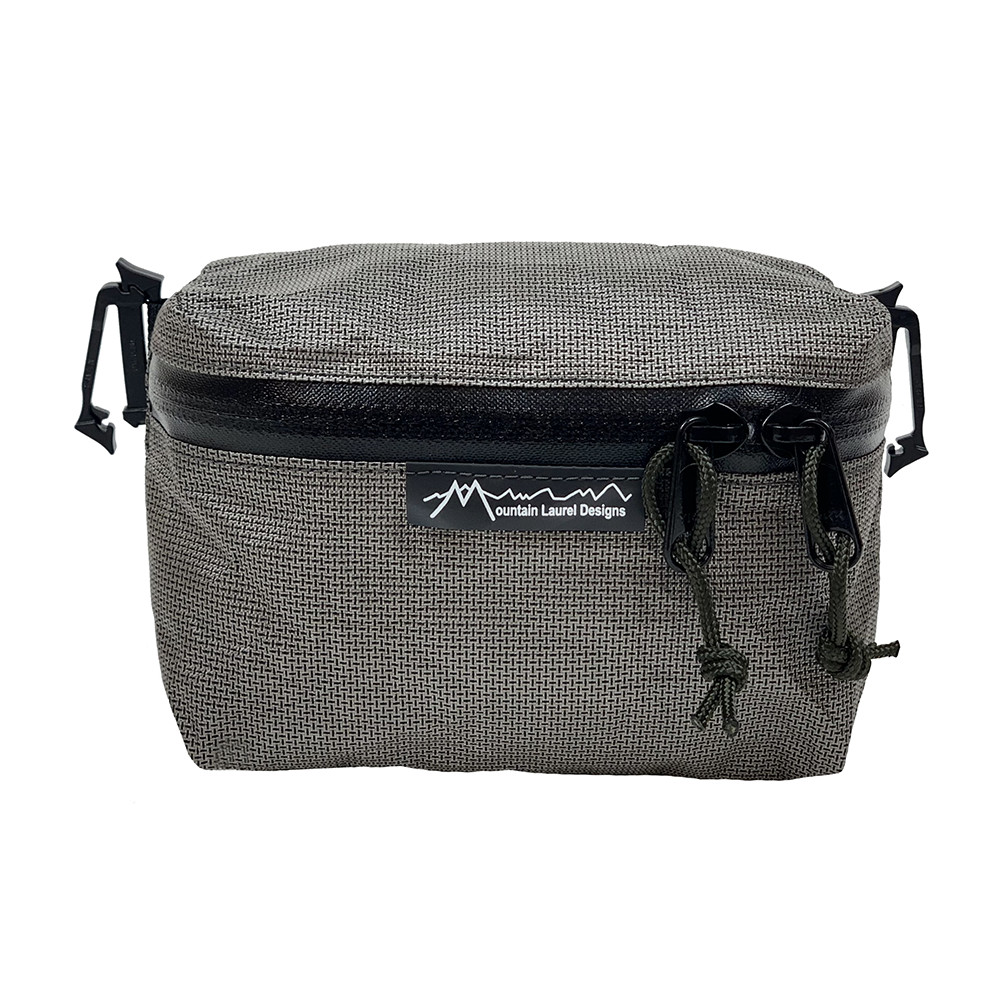 A front view of the MLD Pack Pocket. It is zipped closed.