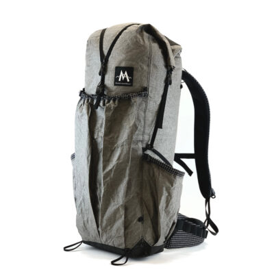 A 3/4 side view of the MLD Burn 38L backpack (2300 Cu In)