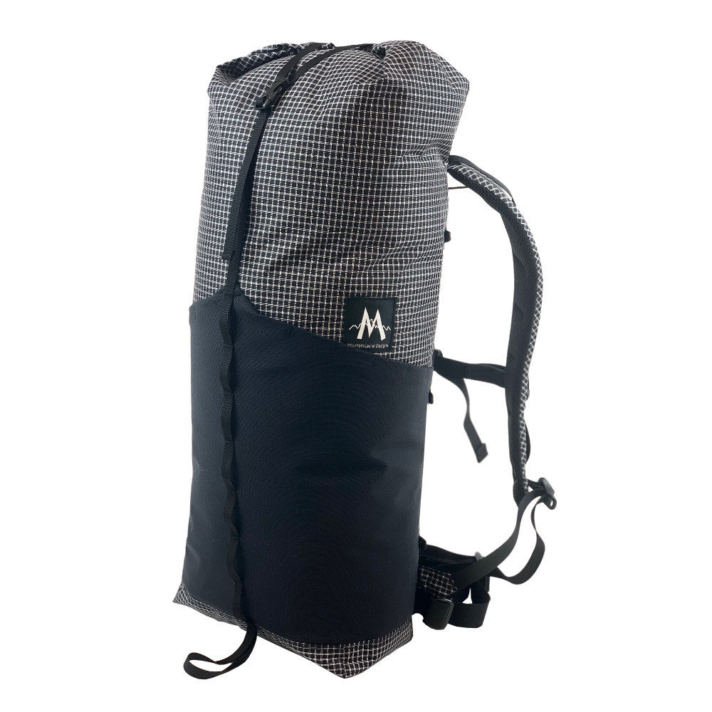 A 3/4 front view of the MLD Hell 27L pack in Black Beauty UltraGrid