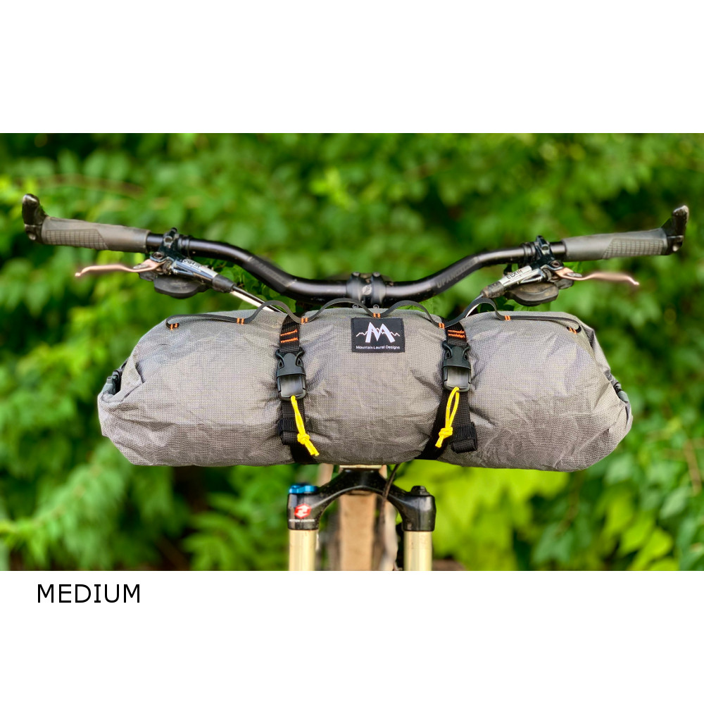 Image shows a Medium double-ended dry bag on the handlebars of a bicycle.