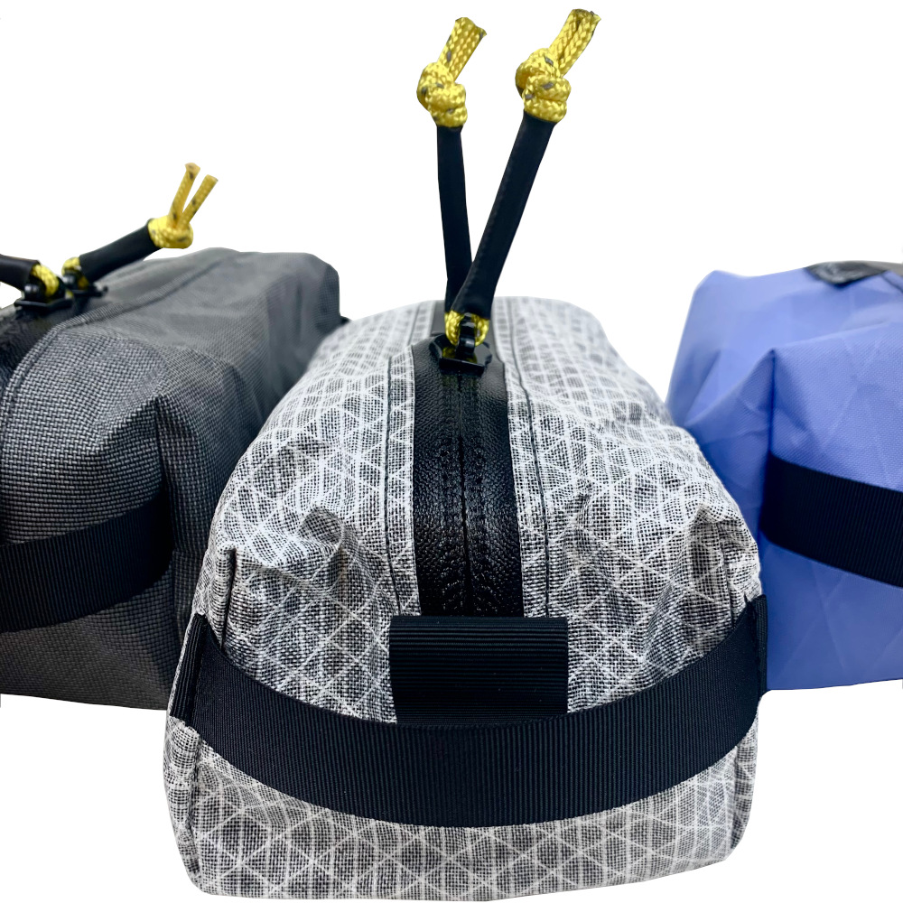 Up close of webbing grip loop,YKK water-resistant zipper, and reflective cord zipper pull tabs.